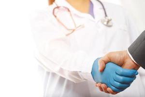 Businessman shaking hands with a doctor photo