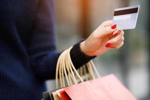 woman person holding a wallet in the hand of a  take credit card out of pocket. Cost control expenses shopping in concept. Leave space to write descriptive text. photo