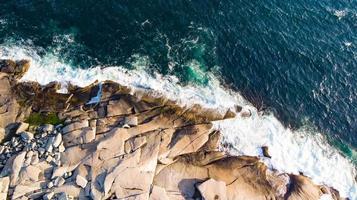 Waves hitting the rocks Aerial on Peggy's Cove, Nova Scotia, Canada photo