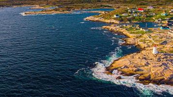 Lighthouse and the Waves hitting the Rock Aerial View - Peggy's Cove, Nova Scotia, Canada photo