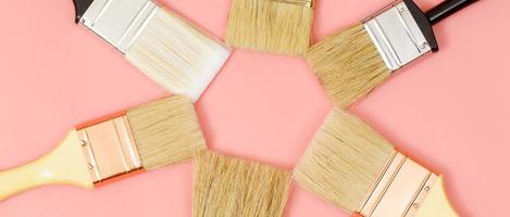 Paint brush on pink background, how to choose the perfect home paint color and good for health photo
