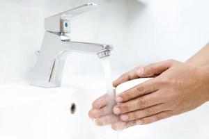 Hygiene. Cleaning Hands. Washing hands with soap under the faucet with water Pay dirt. photo