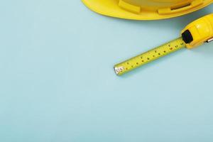 yellow tape measure background in the project at construction site building on concrete floor on city with sunlight. tool for workman as engineer or worker. photo