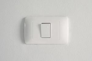 Electronic lighting switch with white wall background. home electrical power. photo