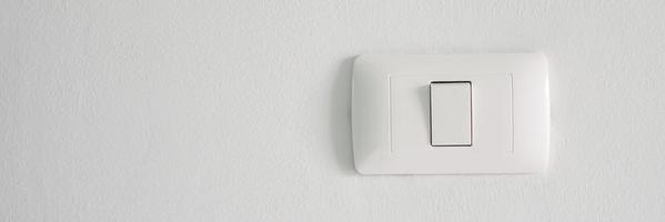 Electronic lighting switch with white wall background. home electrical power. photo