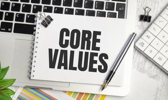 Core Values text and notepad with pen, charts and calculator photo