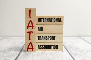 wooden cube block with IATA business word on table background. Mission, Vision and core values concept photo