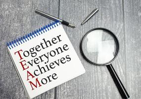 together everyone achieves more words, pen and magnifying glass photo