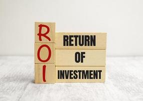 Return on Investment, ROI. Cube wooden block with alphabet building the word ROI. photo