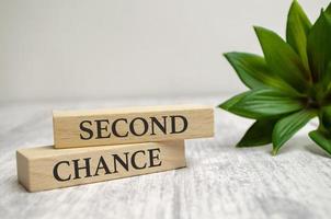 SECOND CHANCE text on a wooden block. Business concept photo