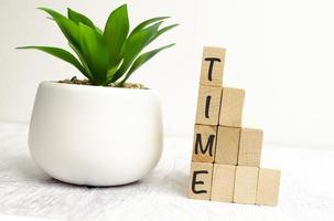 word time on wooden blocks and white wooden background photo