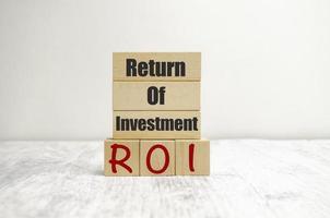 Return on Investment, ROI. Cube wooden block with alphabet building the word ROI. photo