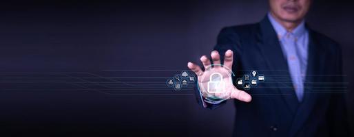 Cybersecurity and privacy concepts to protect data. Lock icon and internet network security technology. Businessman protecting personal data on smart phone with virtual screen interfaces. photo