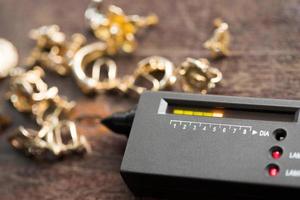 Many expensive decorative Ring, Earrings ready to check real or not with Diamond Tester Gemstone Selector Gems LED Indicator Jewelry kits Test, Portable electronic device to peep quick selective focus photo