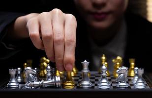 Business woman play Chess with close up Hand. Leader use strategy game to challenge competitor with intelligence leadership to move King to victory with management team idea fight, copy space photo