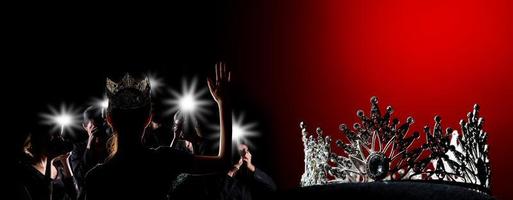 Silver Diamond Crown of Miss Pageant Beauty Universe World Contest sparkle light on black pillow with media press camera shoot flash to winner, studio lighting super red gradient background dramatic photo