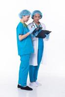 Full length Professional physician Doctor stand in hospital uniform discuss patient chart condition on Tablet. Woman Practitioner wear coat confident in clinic, isolated white background photo