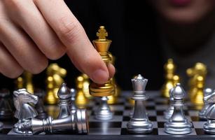 Business woman play Chess with close up Hand. Leader use strategy game to challenge competitor with intelligence leadership to move King to victory with management team idea fight, copy space photo