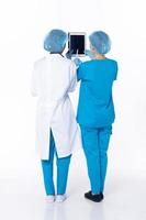 Full length Professional physician Doctor stand in hospital uniform discuss patient chart condition on Tablet. Woman Practitioner wear coat confident in clinic, isolated white background photo