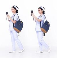 Full length 30s 20s Asian Woman Nurse hospital, walking forward left right, wear formal uniform pant shoe. Smile Hospital female carry backpack coffee cup internet phone over white background isolated photo