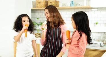 Group of Diverse Family, Asian and Arab Preschool African Arab kid person make Cake cooking in kitchen, Mother prepare decoration pretty with fun educate on snack. Cream mess all over face, copy space photo