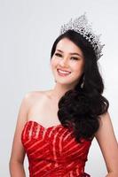 Portrait of Miss Pageant Contest in Asian Red Sequin Evening Ball Gown dress with Silver Diamond Crown Sash, fashion make up face hair style, studio lighting white background isolated copy space photo