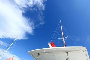 Many Luxury Yachts float on crystal clear sea in Marina Bay Club, expensive Private boat stay calm in docking pier under summer blue sky green ocean photo