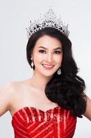 Portrait of Miss Pageant Contest in Asian Red Sequin Evening Ball Gown dress with Silver Diamond Crown Sash, fashion make up face hair style, studio lighting white background isolated copy space photo
