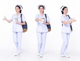 Full length 30s 20s Asian Woman Nurse hospital, shaking hand hello, wear formal uniform pant shoes. Smile Hospital female carry backpack coffee cup internet phone over white background isolated photo