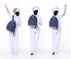 Full length 30s 20s Asian Woman Nurse hospital, pointing finger up in Air, wear formal uniform pant shoes. Smile Hospital female carry backpack coffee cup internet phone over white background isolated photo