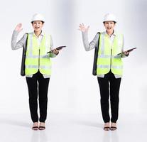 Full length 20s young Mix Race engineer architect client Woman, wow surprise glad, wear safety vast hardhat tablet. Office female stands feels smile happy over white background isolated photo