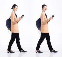 Full length 20s young Mix Race Woman business salesman backpacks, walking forward left right, wear formal blazer and shoes. Office female stands feels happy smile over white background isolated photo