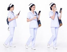 Full length 30s 20s Asian Woman Nurse hospital, walking forward left right, wear formal uniform pant shoe. Smile Hospital female carry backpack coffee cup internet phone over white background isolated photo