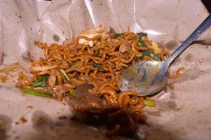 Fried noodles sold on the side of the road in Indonesia. food wrapping paper. photo