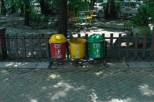 sidoarjo, march, 2022 - trash cans with different colors for different types of garbage in city parks photo