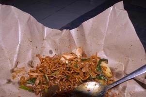 Fried noodles sold on the side of the road in Indonesia. food wrapping paper. photo