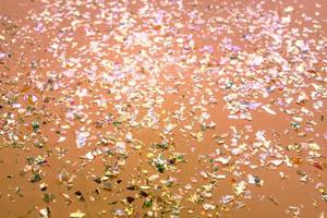 Neon pearl confetti and sparkles background. Top view, flat lay. Copyspace for text. Bright and festive holiday background. For Christmas, New year, Mother's day. photo