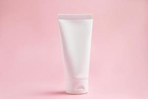 mockup of white squeeze bottle plastic tube for branding of medicine or cosmetics - cream, gel, skin care, toothpaste. Cosmetic bottle container on a pink background. Minimalism photo