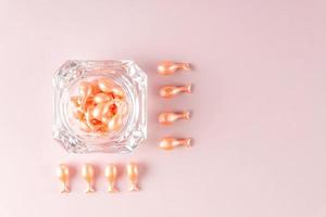 Single-dose serum capsules with active ingredients in a crystal shape container. Skin care and beauty products photo