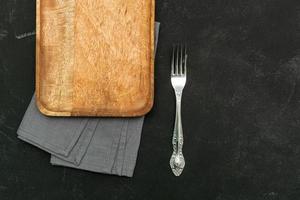 Top view of empty wooden tray served with napkin and fork. Copy space for text. photo