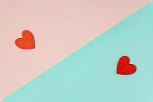 Valentine's day concept with two red hearts on light blue background, top view, copy space. Creative flat lay photo