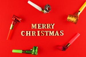 wooden letters on red background. Merry christmas lettering in red paper. Copy space photo