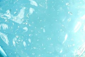 Blue liquid gel texture background. Abstract liquid with bubbles. Cosmetic swatch photo