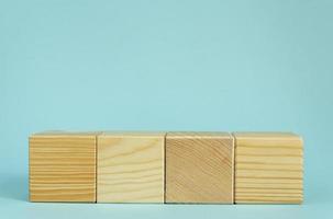 Construction of wooden cubes on blue background with copy space. Mockup composition for design photo