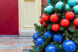 close up of christmas tree decoration with baubles and garland. Festive greeting card for winter holidays. photo