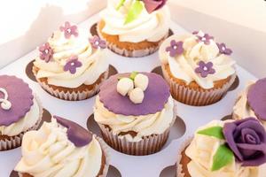 Set of different delicious cupcakes in a paper box for celebration. photo