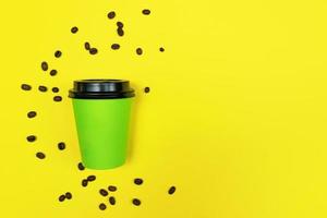 Close up of coffee to go cup on bright yellow background. Eco concept. Place for text. photo