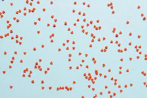 sprinkles background, sugar sprinkle red hearts, decoration for cake and bakery. Top view, flat lay. Valentines holiday photo