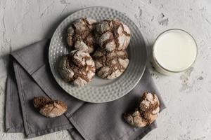 top view of glass of milk with crispy crunchy chocolate cookies. Tasty snack or breakfast. photo