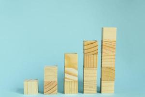 Construction of wooden cubes on blue background with copy space. Mockup composition for design photo